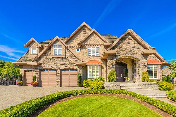Realtor Odessa, TX Brown Brick Home with green lawn in Odessa, TX